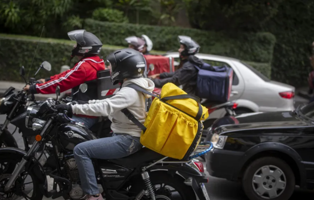 Imagem representativa da transformação do delivery no Brasil mostrando uma pessoa fazendo um pedido por smartphone com diversos alimentos ao fundo.